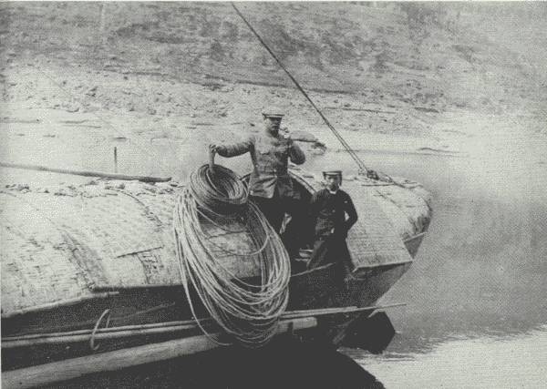 SCENE ON THE UPPER YANGTZE

Author and the cook on the aft of the houseboat after all the dangerous
rapids had been passed. The ropes are made of bamboo. En route to
Chung-king.