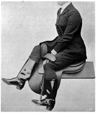 Woman seated in side-saddle on stand